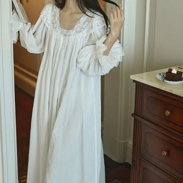 White cotton nightgown showing the lace neckline and gathered sleeves